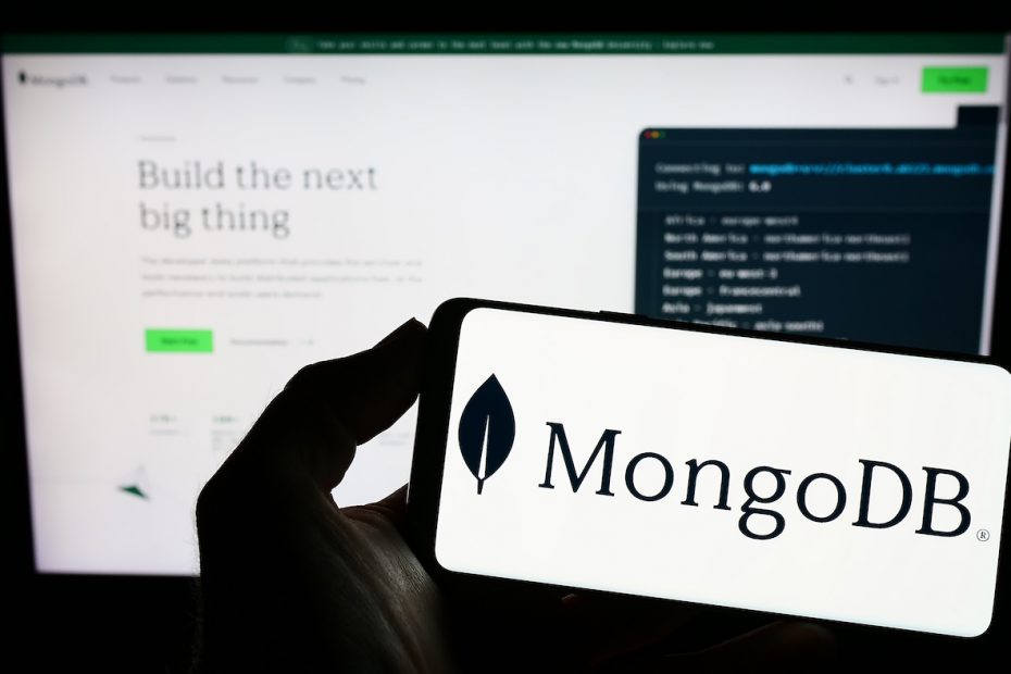 The MongoDB logo on a phone in front of their website.